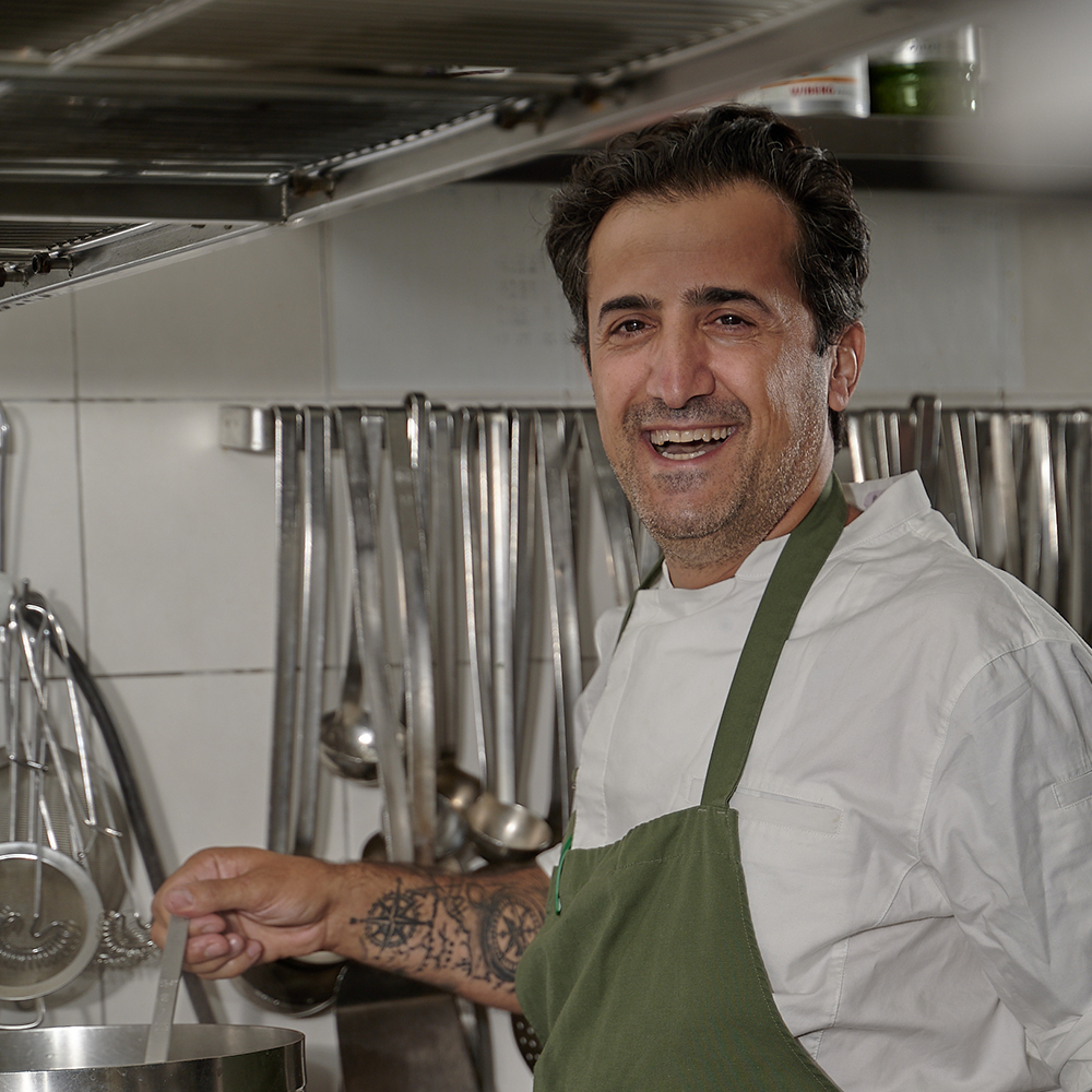 Matthias Schicht, der Küchenchef des Weißen Rauchfangkehrers hält eine Pfanne über den Herd